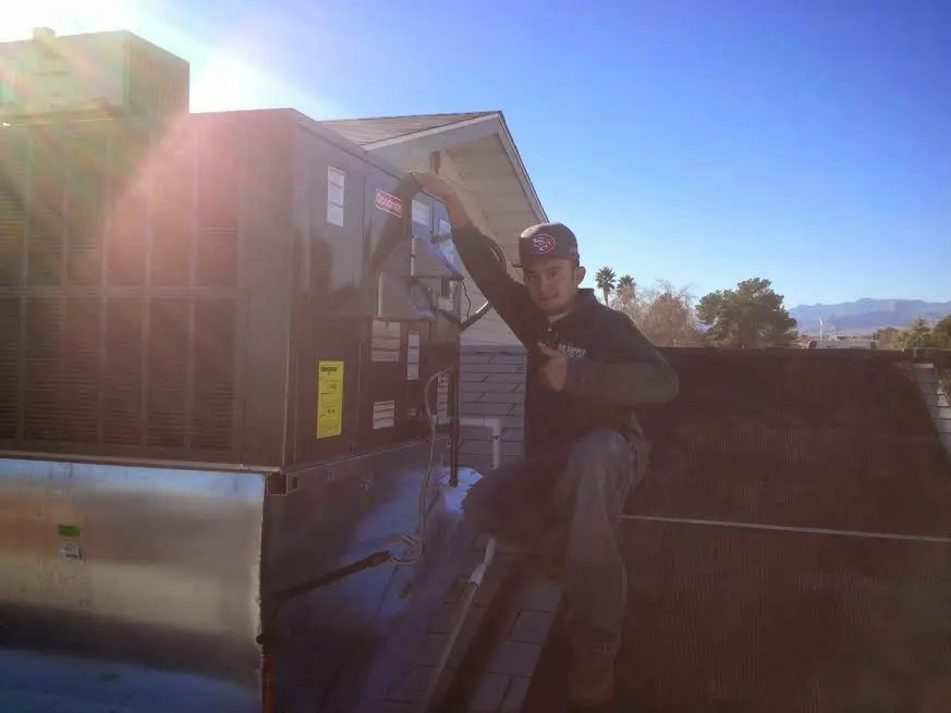 HVAC technician performing HVAC Inspection on a rooftop unit in Honey Brook